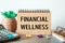 Notebook with text Financial Wellness near office supplies