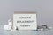 Notebook with text Hormone Replacement Therapy, pills, stethoscope and syringes on light grey marble grey table
