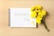 Notebook with words TEACHER`S DAY and beautiful yellow flowers on wooden table, flat lay