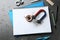 Notebooks, compass and magnet with iron powder on table, flat lay composition.