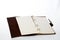 Notebookwith leather cover, notepad on white background with space for text