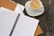 Notepad with blank pages and cup of coffe