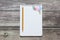 Notepad with a blank white sheet in a checker paper with simple graphite pencil and with paper clips lies on the background of