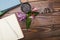 Notepad, flowers and scrub on a wooden table