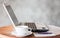 Notepad, laptop and coffee cup on wood table