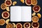 Notepad next to dry fruit slices on a dark background