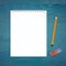 Notepad with pencil and eraser on wood blue plank desk