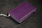 Notepad purple on a black background top view. Stationery
