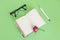Notepad, stationery pen, glasses and pink rose