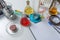 Notepad, tablets with additives E, test tubes and laboratory equipment. Food laboratory. Close up on a white table