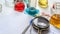 Notepad, tablets with additives E, test tubes and laboratory equipment. Food laboratory. Close up on a white table