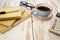 Notepads, calculator and a cup of coffee on a retro wooden table