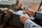 Notes. Close up of hands of psychologist making notes while communicating with military man during therapy session