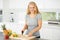 Nothing beats fresh fruit. Attractive curvaceous young woman chopping fruit in her kitchen.