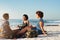 Nothing beats a sunny day with friends on the beach. Rearview shot of an attractive young trio of women having a picnic