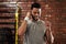 Nothing boosts your workout like really good beats. Shot of a young man stretching using earphones during his workout in