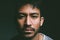 Is nothing an emotion because I feel that. Studio shot of a young man staring blankly against a dark background.