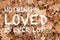 Nothing loved is ever lost quote on oak leaves textured background