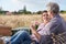 Nothing more romantic than a picnic. A loving mature couple enjoying an intimate picnic together in a scenic field.