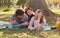 Nothing says family time like a picnic in the park. a happy young family enjoying a picnic in the park.