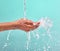 Nothing tastes as good as skin feels. an unrecognisable woman cupping her hands to catch water against a blue background