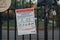 Notice about accessing parks on a fence outside a park in Enfield, London, UK