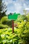 Notice board, green blank plate for text in the park on natural background