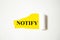 Notify word written on yellow paper and white background