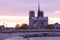 Notre Dame Cathedral on Ile de la Cite and Pont de la Tournelle over Seine river in Paris