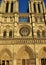 Notre Dame Cathedral, Paris, France. Gothic facade closeup with sunset light. Towers, statues, rose window, archs and doors.