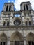 Notre Dame of Paris. Facade detail and tower against a blue sky
