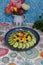 Nourish with vibrant flavors! Nutrient-rich cauliflower salad, cucumber, blueberries, floral tablecloth - a healthy delight!