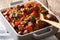 Nourishing food: stewed broad beans with tomatoes and herbs closeup. horizontal