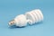 Novel fluorescent light bulb on blue background