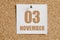 november 03. 03th day of the month, calendar date.White calendar sheet attached to brown cork board.Autumn month, day of