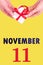 November 11th. Festive Vertical Calendar With Hands Holding White Gift Box With Red Ribbon And Calendar Date