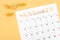 November 2022 calendar and wooden push pin on yellow background