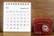 The November 2022 Monthly desk calendar for the organizer to plan 2022 year with a vintage red radio against a wooden table