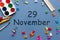 November 29th. Day 29 of last autumn month, calendar on blue background with school supplies. Business theme
