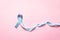 November light blue ribbon on pink background with copy space, Prostate cancer awareness month, men`s health concept