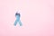 November light blue ribbon on pink background with copy space, Prostate cancer awareness month, men`s health concept