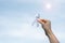 November Lung Cancer Awareness month, democracy and international peace day. Woman holding white Ribbon on sky background