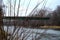 November river gray water bushes bridge sky grass