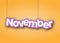 NOVEMBER. A sign with the name of the month of the year hangs on the ropes