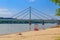 Novi Sad, Serbia - July 3, 2019: People enjoy on a beach on a Danube river, view at Liberty Bridge in Novi Sad, Serbia