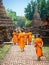 Novice Buddhist Monks Walking Among Ruins in Sukhothai, Thailand