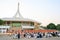 Novice monk or priest and people sitting for meditation at Ratchamangkhala Pavillion of public park name Suan Luang Rama IX on eve