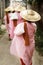 Novice nun walking with bamboo hat