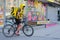 Novosibirsk, Russia-30.04.2020: a fast food delivery courier dressed in a yellow uniform delivers it on a bicycle