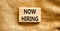 Now hiring symbol. Concept words Now hiring on beautiful wooden block. Beautiful canvas table canvas background. Business